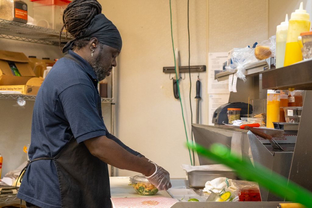 Chef making a salad in the kitchen at GRK airport