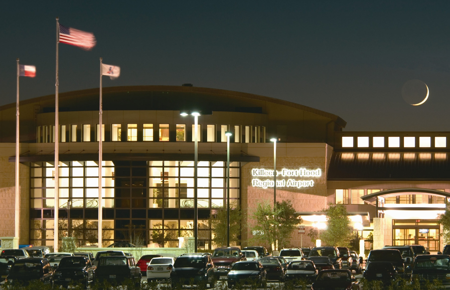 Curbside and parking lot image at night with a crescent moon over the GRK airport terminal in 2004.